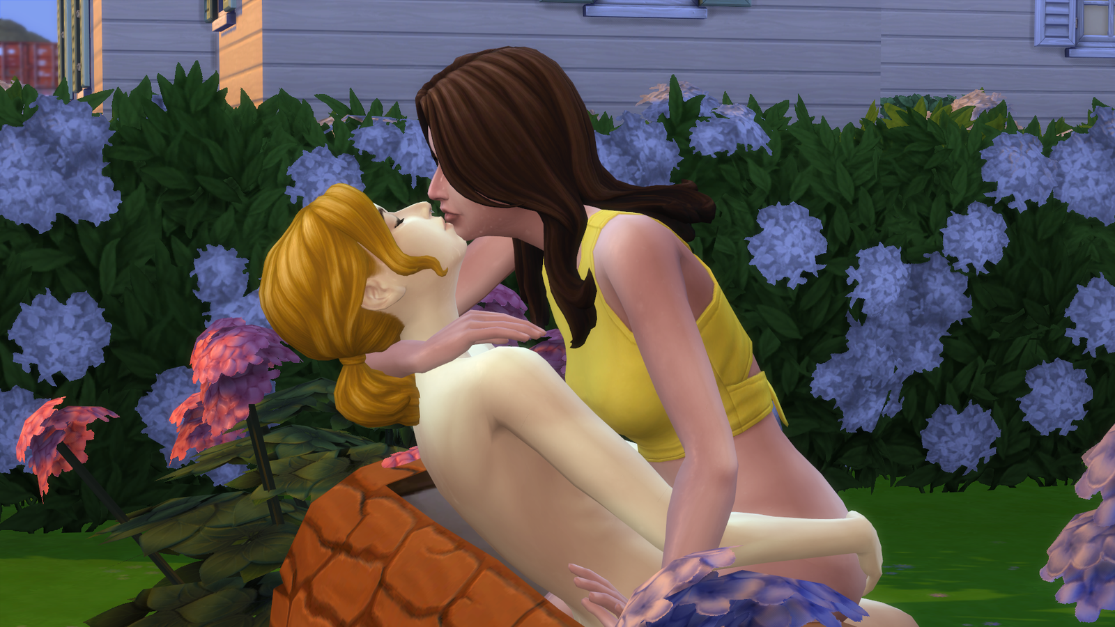 Clover straddles Juniper with her bare legs as they kiss.