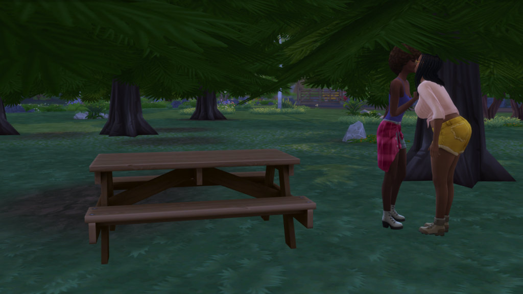 Skye and Jasmine kiss standing next to the bench